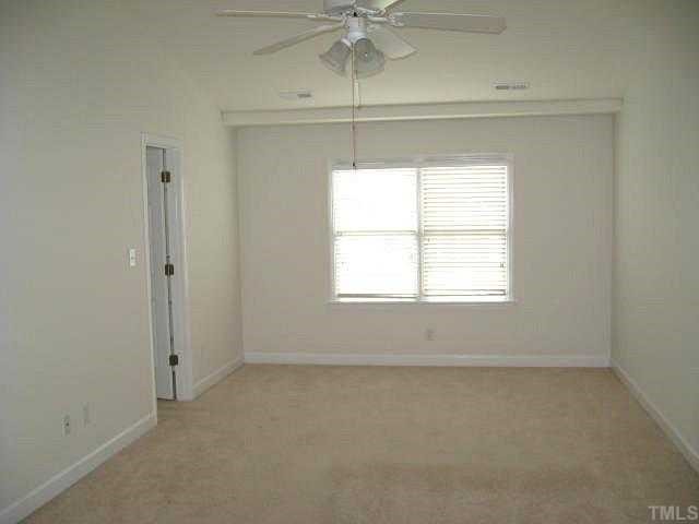 5406 Goldenglow Way Raleigh, NC 27606 - Photo 7 of 12 an empty room with a window