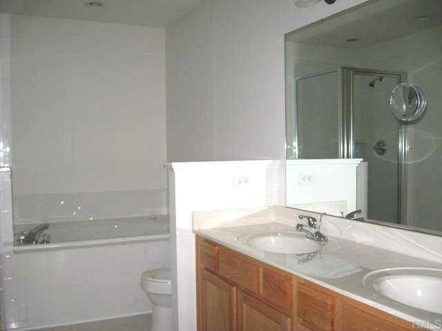 5406 Goldenglow Way Raleigh, NC 27606 - Photo 8 of 12 a bathroom with a sink and a mirror