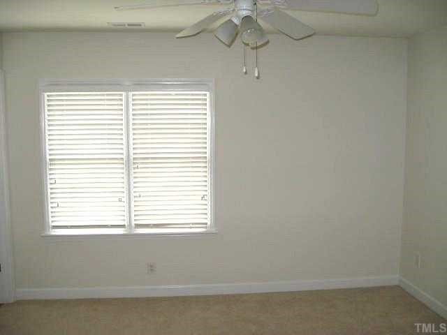 5406 Goldenglow Way Raleigh, NC 27606 - Photo 9 of 12 an empty room with a window