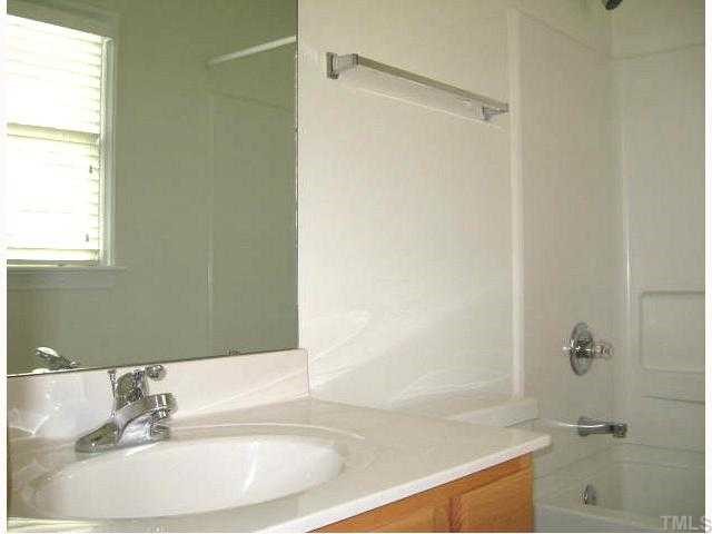 5406 Goldenglow Way Raleigh, NC 27606 - Photo 10 of 12 a bathroom with a sink and a bathtub