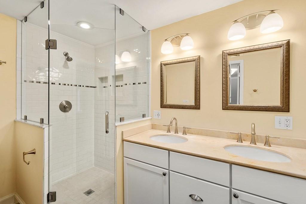 40 Helene Road Newton, MA 02468 - Photo 16 of 27 a bathroom with a double vanity sink mirror and shower