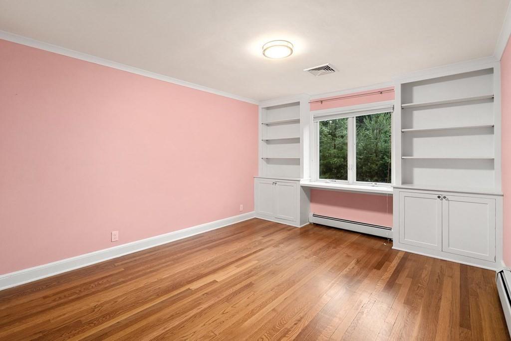 40 Helene Road Newton, MA 02468 - Photo 18 of 27 a view of an empty room with a window and wooden floor
