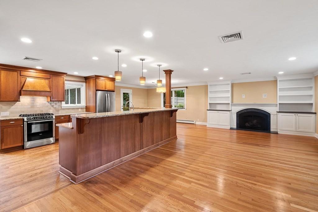 40 Helene Road Newton, MA 02468 - Photo 2 of 27 a kitchen with stainless steel appliances granite countertop a large counter top a stove and a wooden floors