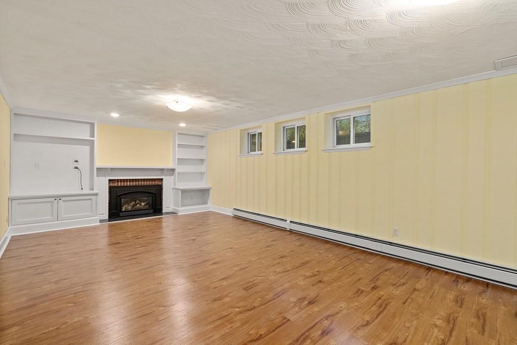 40 Helene Road Newton, MA 02468 - Photo 23 of 27 a view of empty room with wooden floor and fireplace