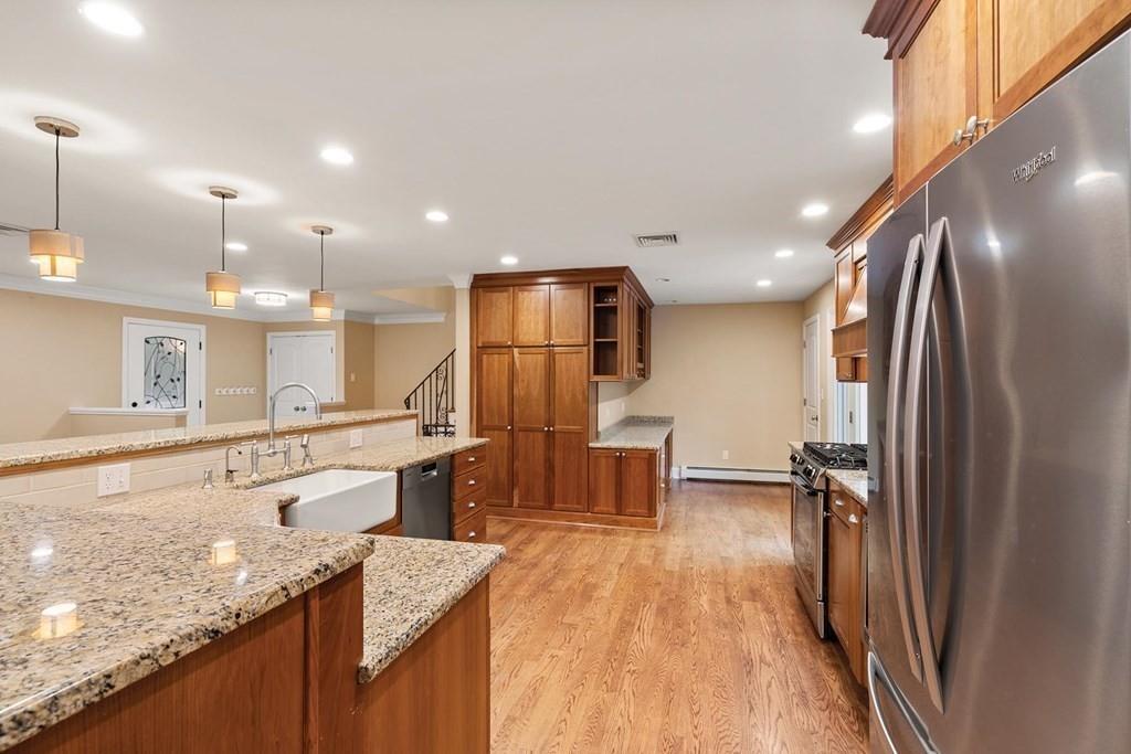 40 Helene Road Newton, MA 02468 - Photo 9 of 27 a kitchen with stainless steel appliances granite countertop refrigerator sink and stove
