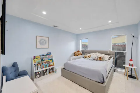 a view of a patio with a table chairs and a swimming pool