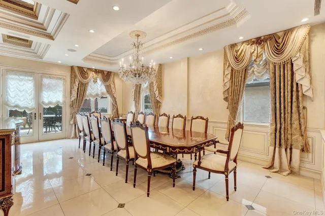 a dining room with furniture a chandelier and a rug