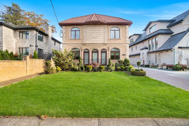 a front view of a house with a yard and potted plants