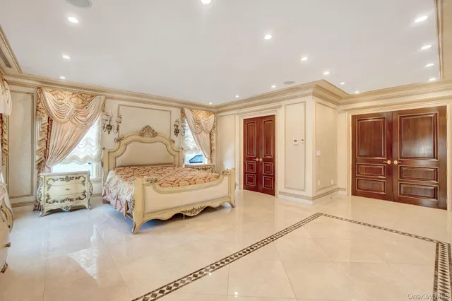 a bedroom with a bed and a large window