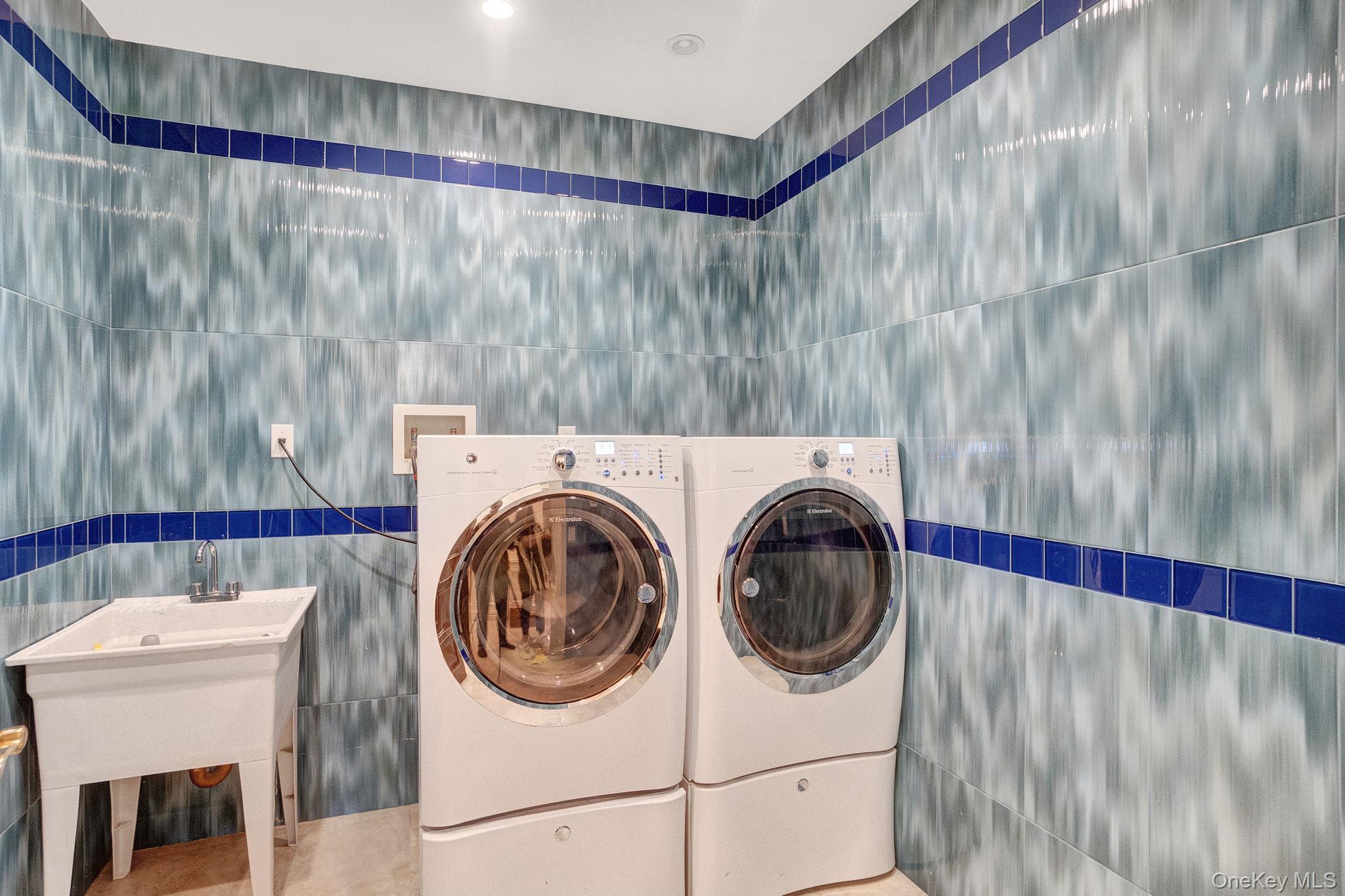 181-30 Tudor Road Queens, NY 11432 - Photo 34 of 46 Washroom featuring tile walls and washer and clothes dryer