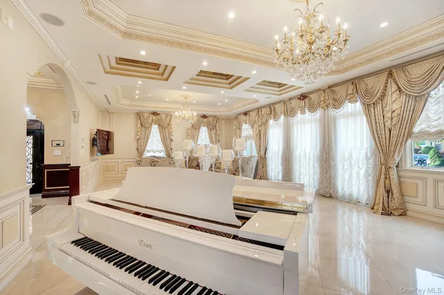 a living room with furniture and a chandelier