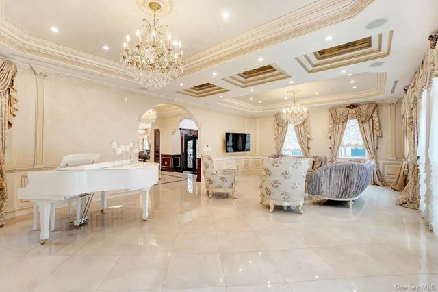 a living room with furniture and a chandelier