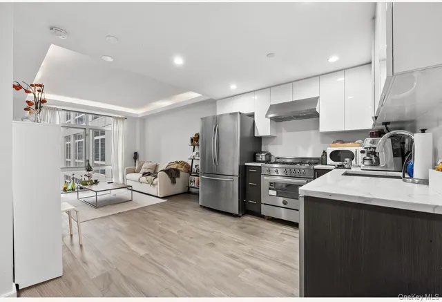 a kitchen with refrigerator a sink and cabinets