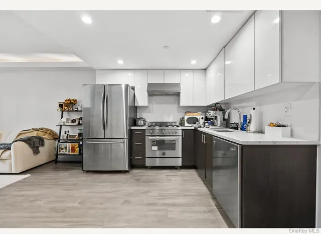 a kitchen with a refrigerator a stove a sink dishwasher and a refrigerator