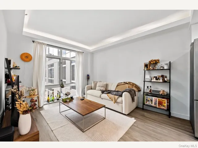 a living room with furniture and floor to ceiling windows