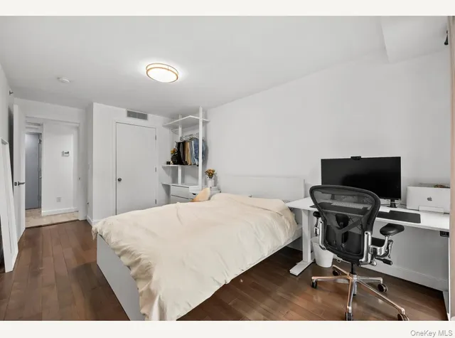 a bedroom with a bed and a chair