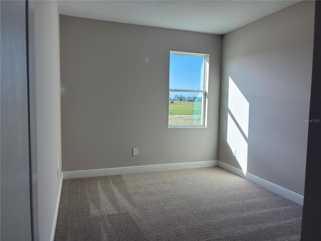 10037 Hidden Hammock Loop Parrish, FL 34221 - Photo 13 of 19 a view of an empty room with a window
