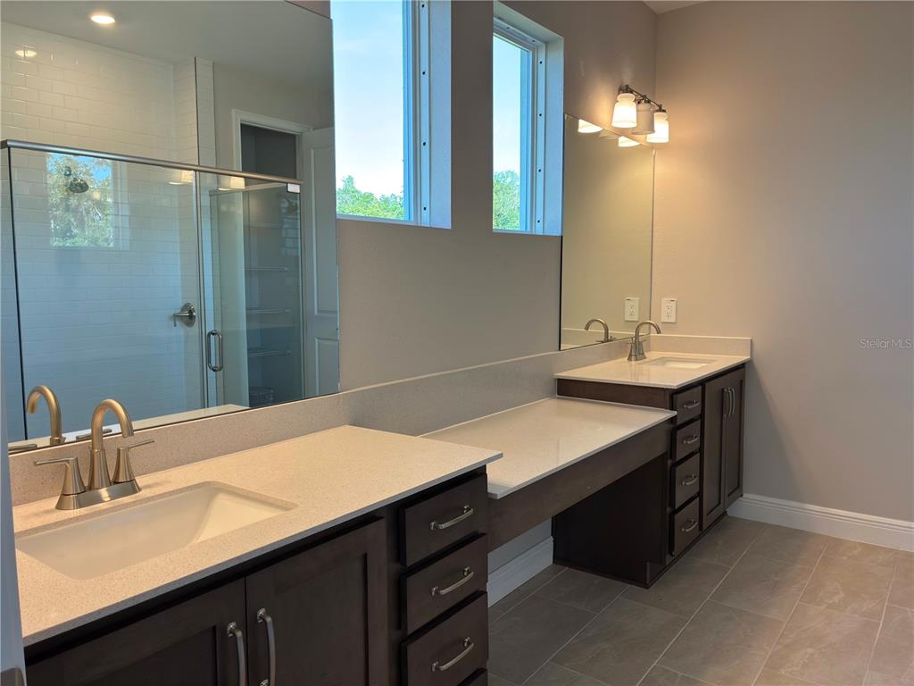 10037 Hidden Hammock Loop Parrish, FL 34221 - Photo 17 of 19 a bathroom with a sink double vanity and a mirror