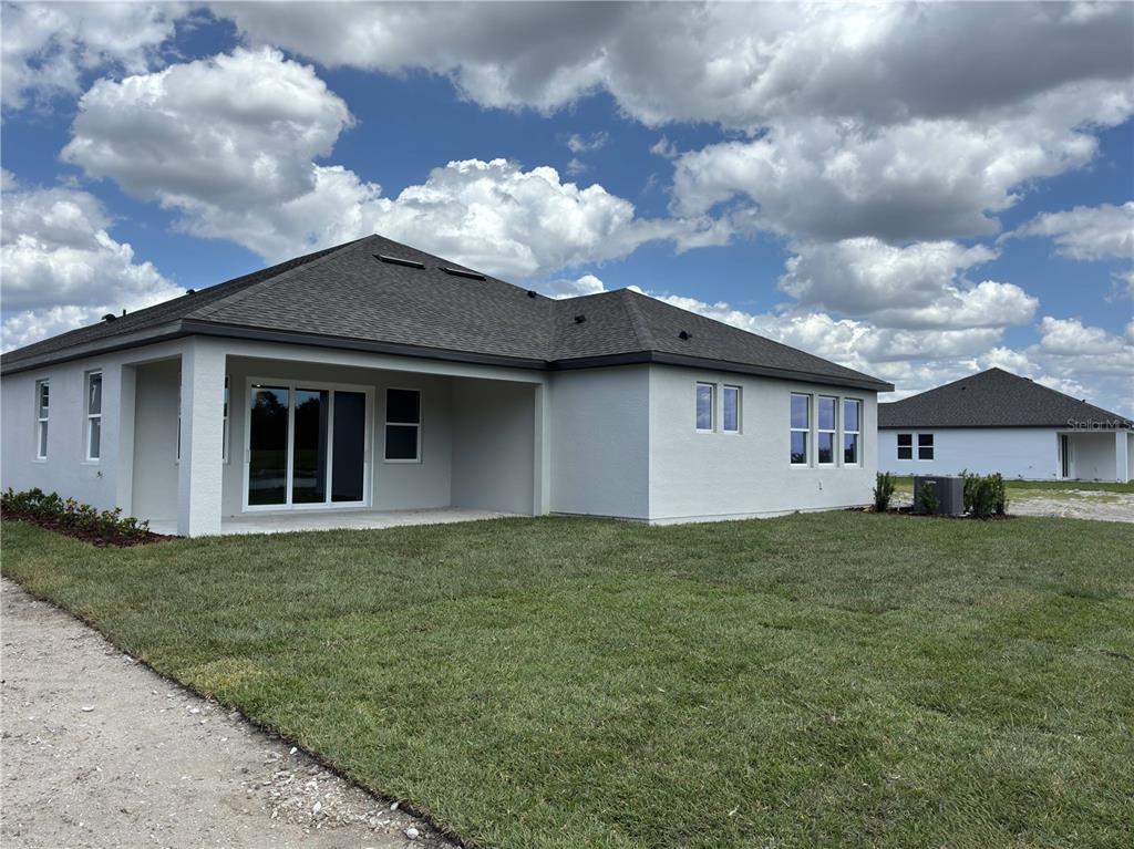 10037 Hidden Hammock Loop Parrish, FL 34221 - Photo 19 of 19 a view of a house with a backyard