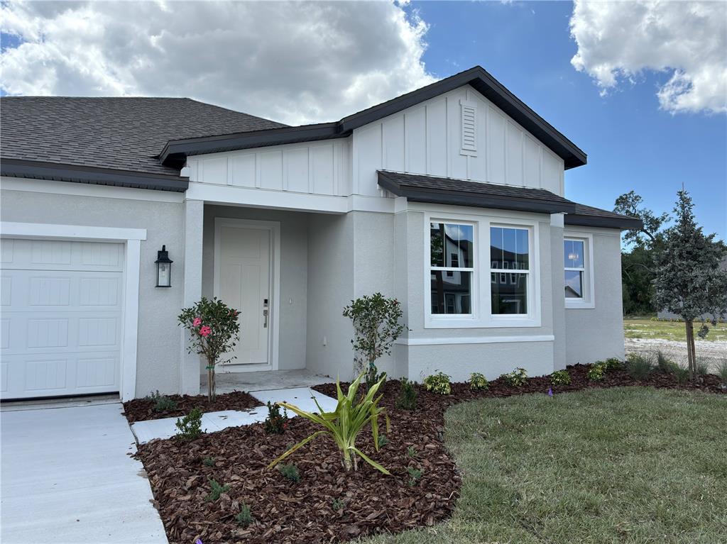 10037 Hidden Hammock Loop Parrish, FL 34221 - Photo 4 of 19 a front view of a house with garden