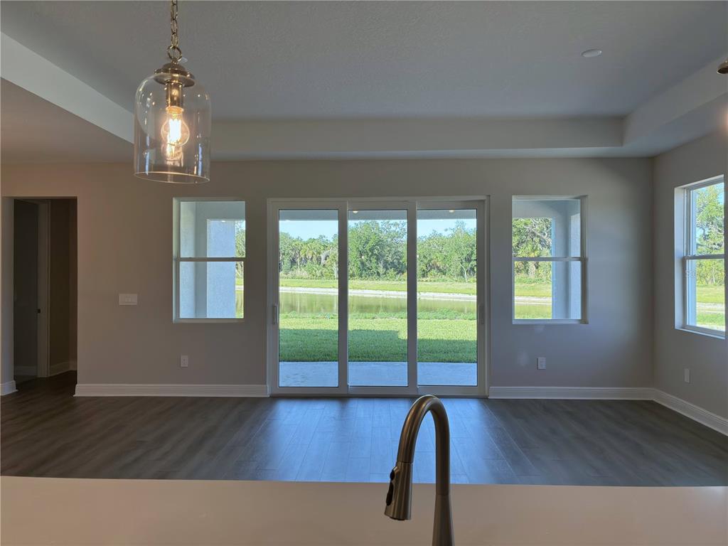 10037 Hidden Hammock Loop Parrish, FL 34221 - Photo 10 of 19 a view of empty room with wooden floor and fan