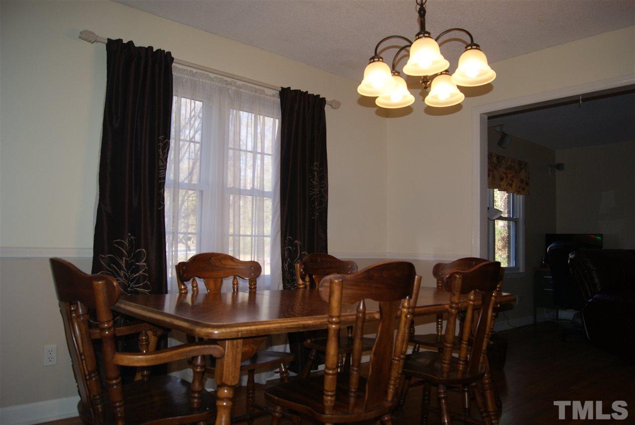 3209 Marie Drive Raleigh, NC 27604 - Photo 13 of 25 a view of a dining room with furniture and chandelier