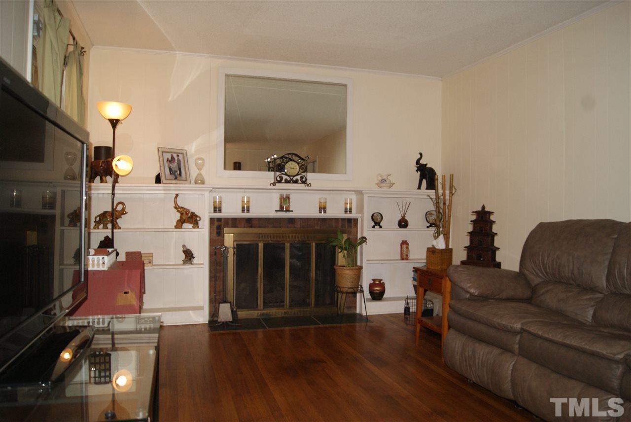 3209 Marie Drive Raleigh, NC 27604 - Photo 16 of 25 a living room with furniture and a fireplace