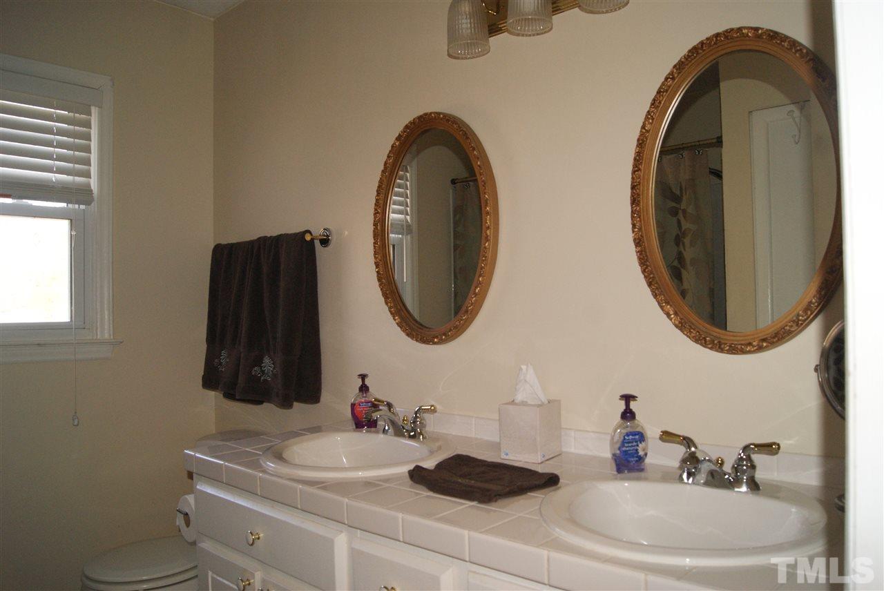 3209 Marie Drive Raleigh, NC 27604 - Photo 20 of 25 a bathroom with a sink and a mirror