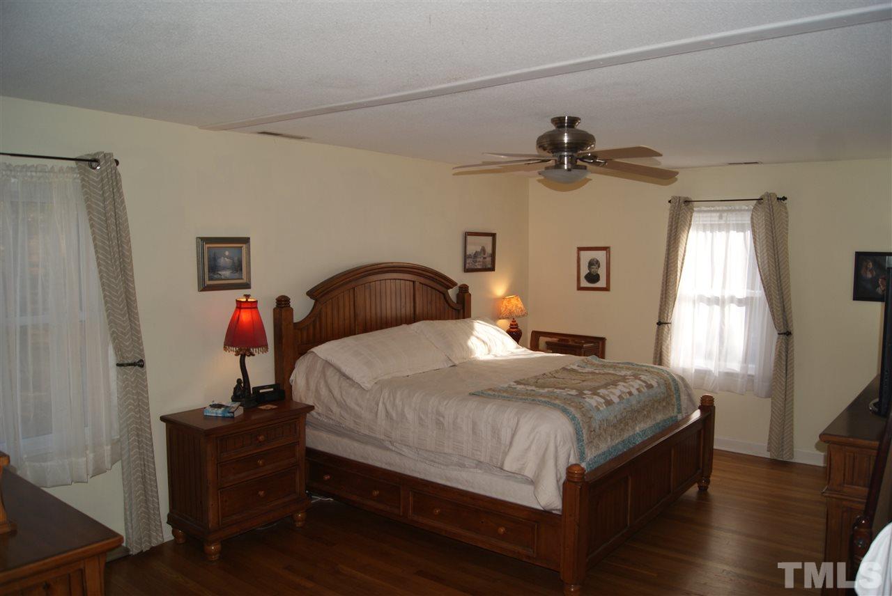 3209 Marie Drive Raleigh, NC 27604 - Photo 21 of 25 a bedroom with a bed and a chandelier