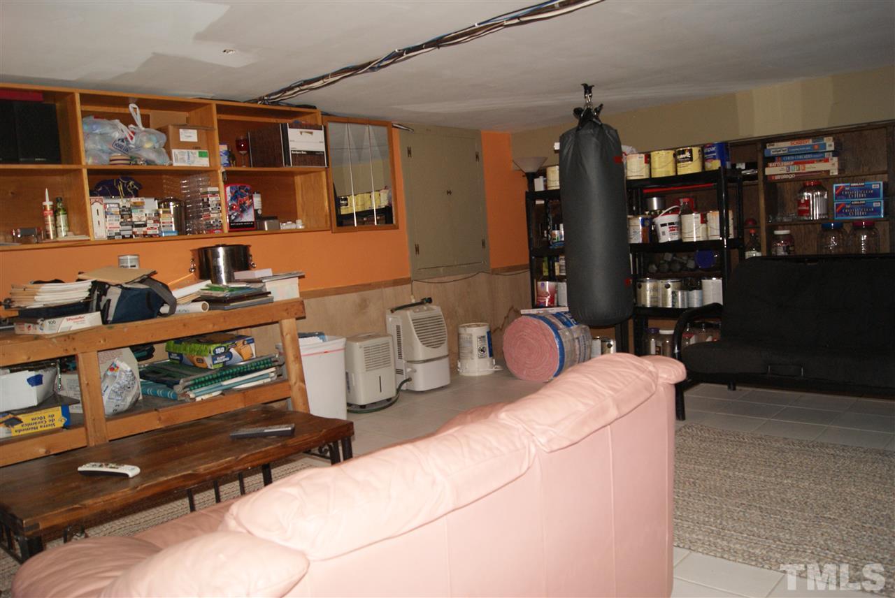 3209 Marie Drive Raleigh, NC 27604 - Photo 23 of 25 a living room with lots of furniture and a book shelf