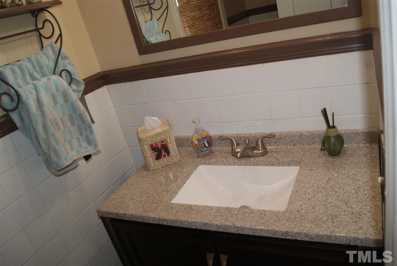 3209 Marie Drive Raleigh, NC 27604 - Photo 25 of 25 a bathroom with a granite countertop sink and a mirror