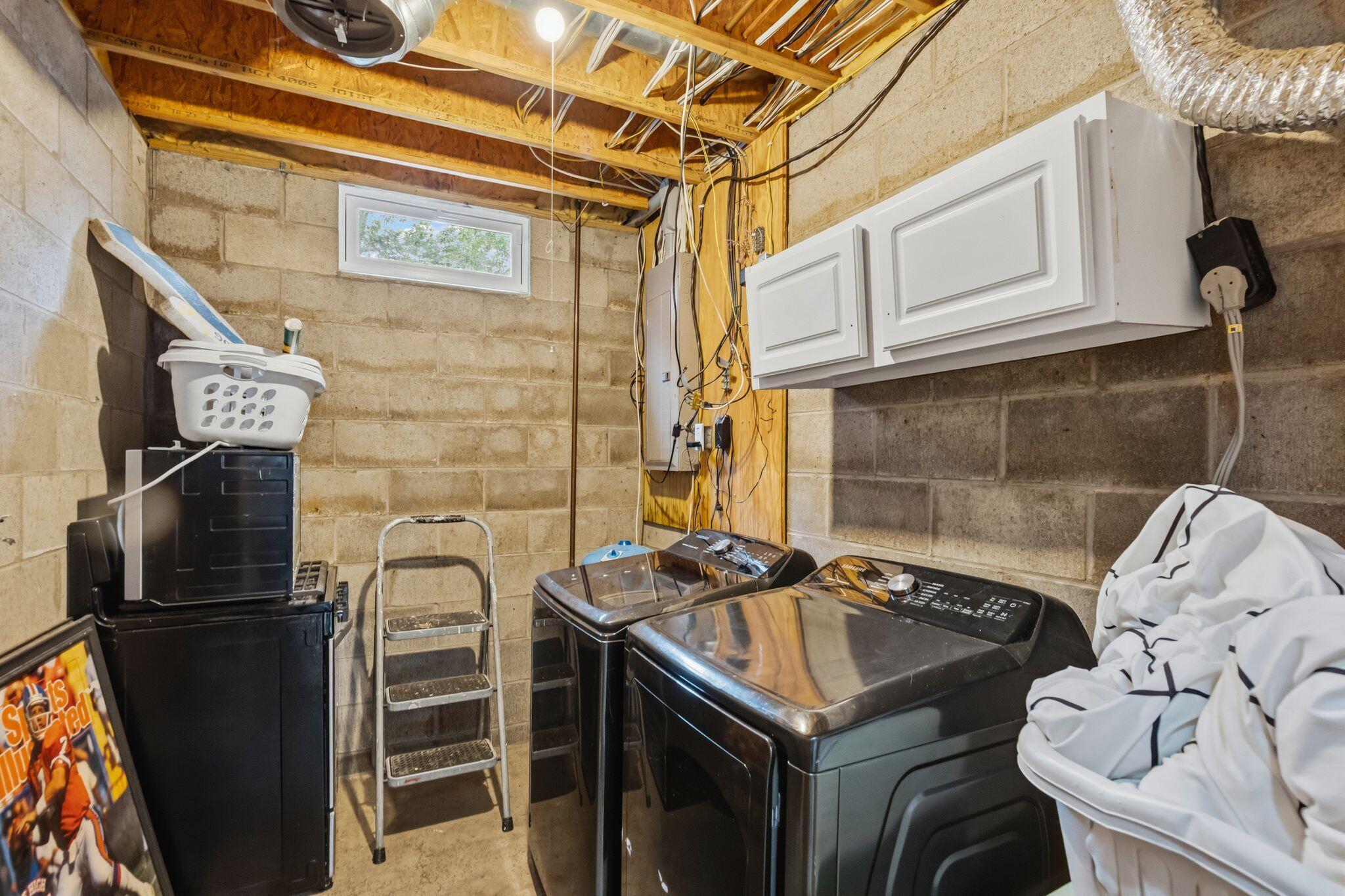 10446 Rich Hollow Road Southwest Lancaster, OH 43130 - Photo 16 of 83 Laundry area featuring concrete block walls and exposed ceiling joists
