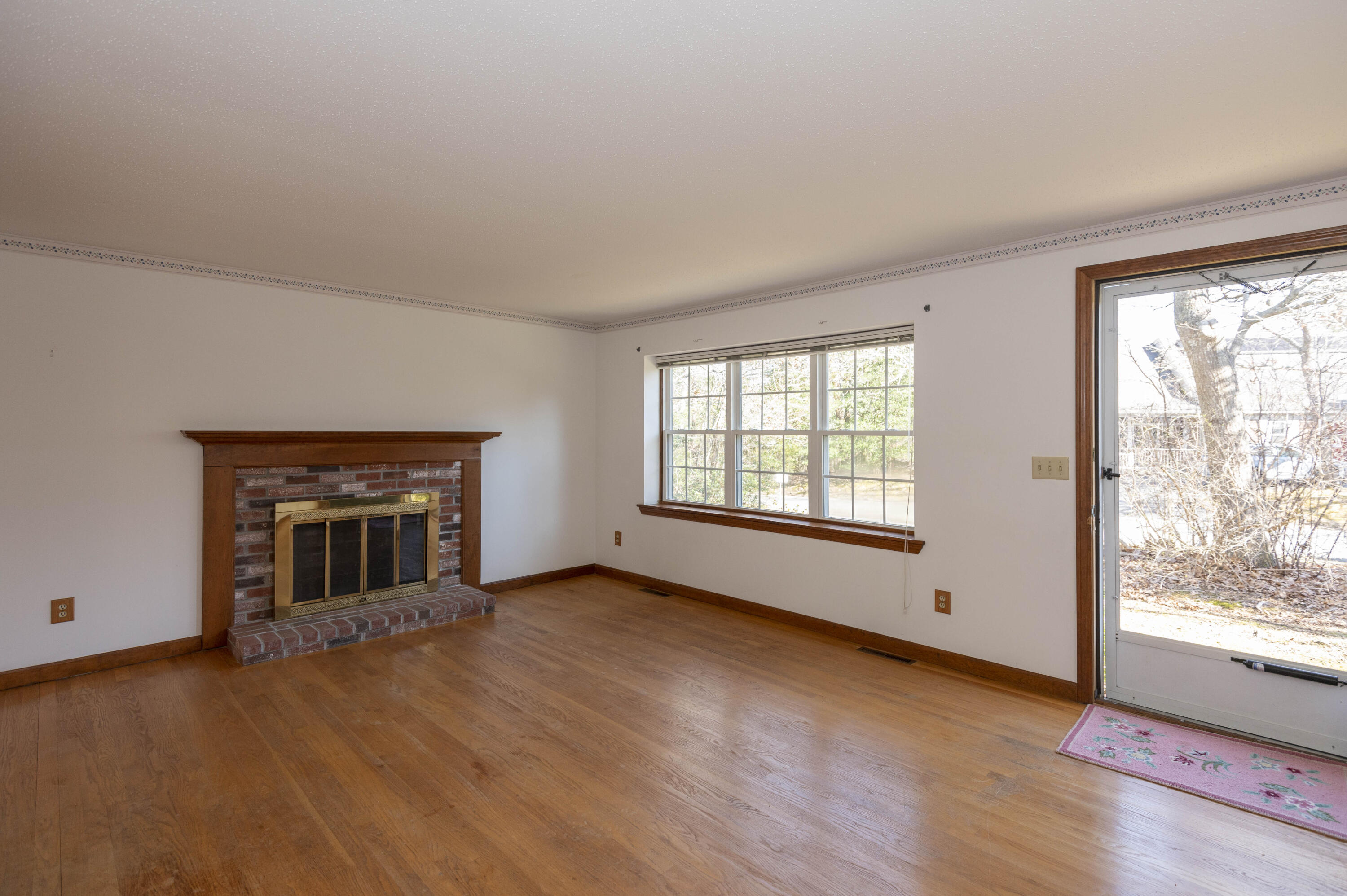 22 Ensign Road Centerville, MA 02632 - Photo 3 of 22 wooden floor fireplace and windows in an empty room