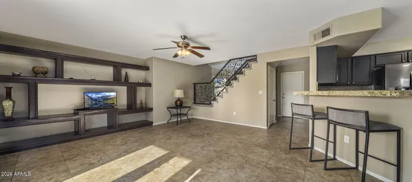 a view of a livingroom with furniture and staircase