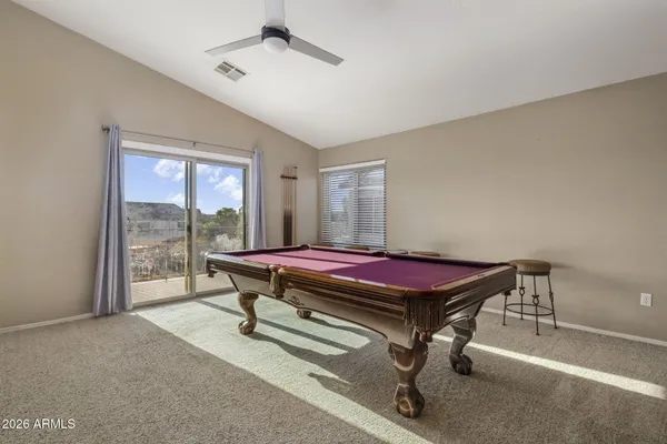 a living room with furniture and a ceiling fan