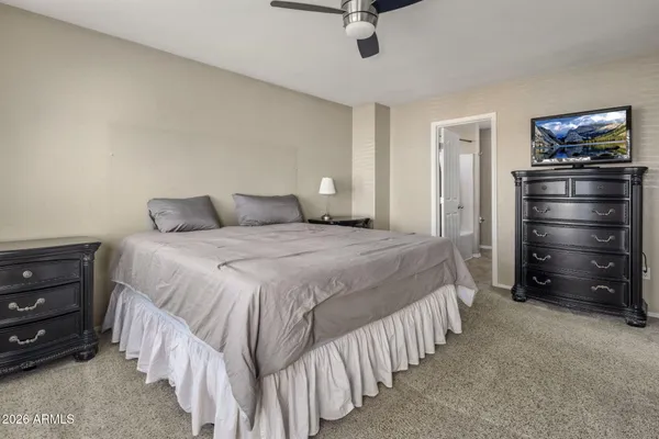 a spacious bedroom with a large bed and a large window