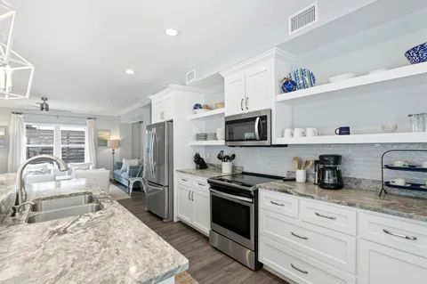 a kitchen with granite countertop cabinets and stainless steel appliances