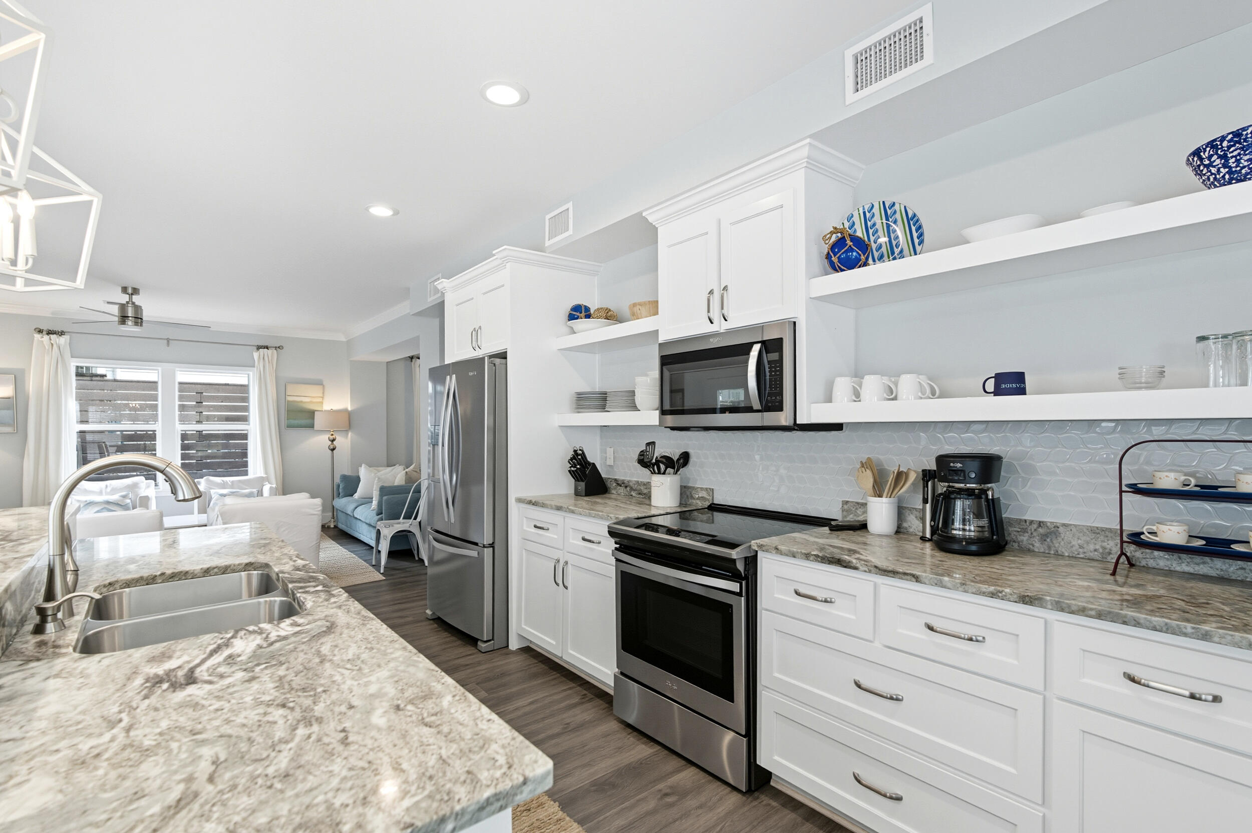 144 Hickory Street Santa Rosa Beach, FL 32459 - Photo 14 of 60 a kitchen with white cabinets and stainless steel appliances