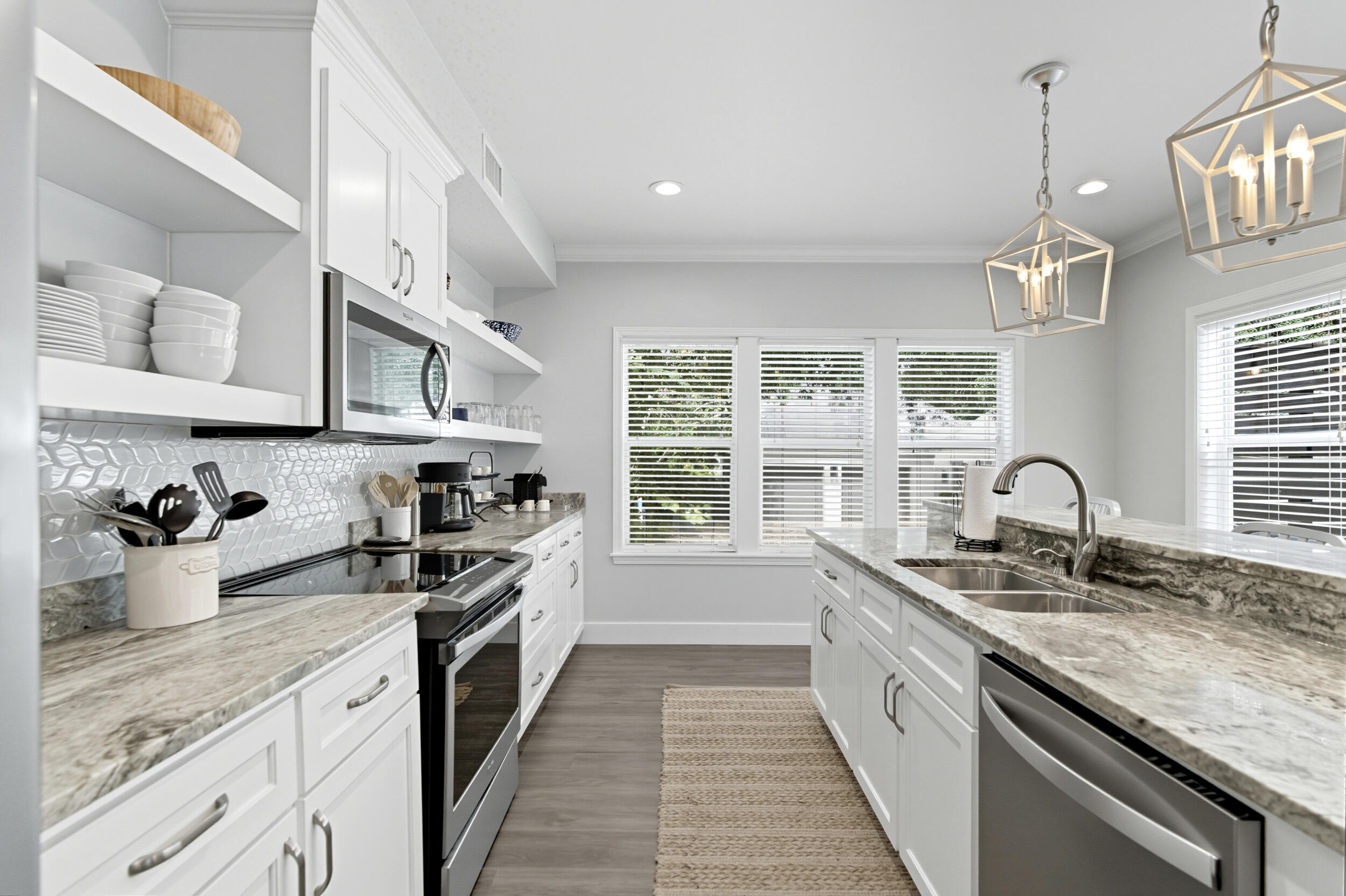 144 Hickory Street Santa Rosa Beach, FL 32459 - Photo 16 of 60 a kitchen with stainless steel appliances granite countertop a sink stove and cabinets