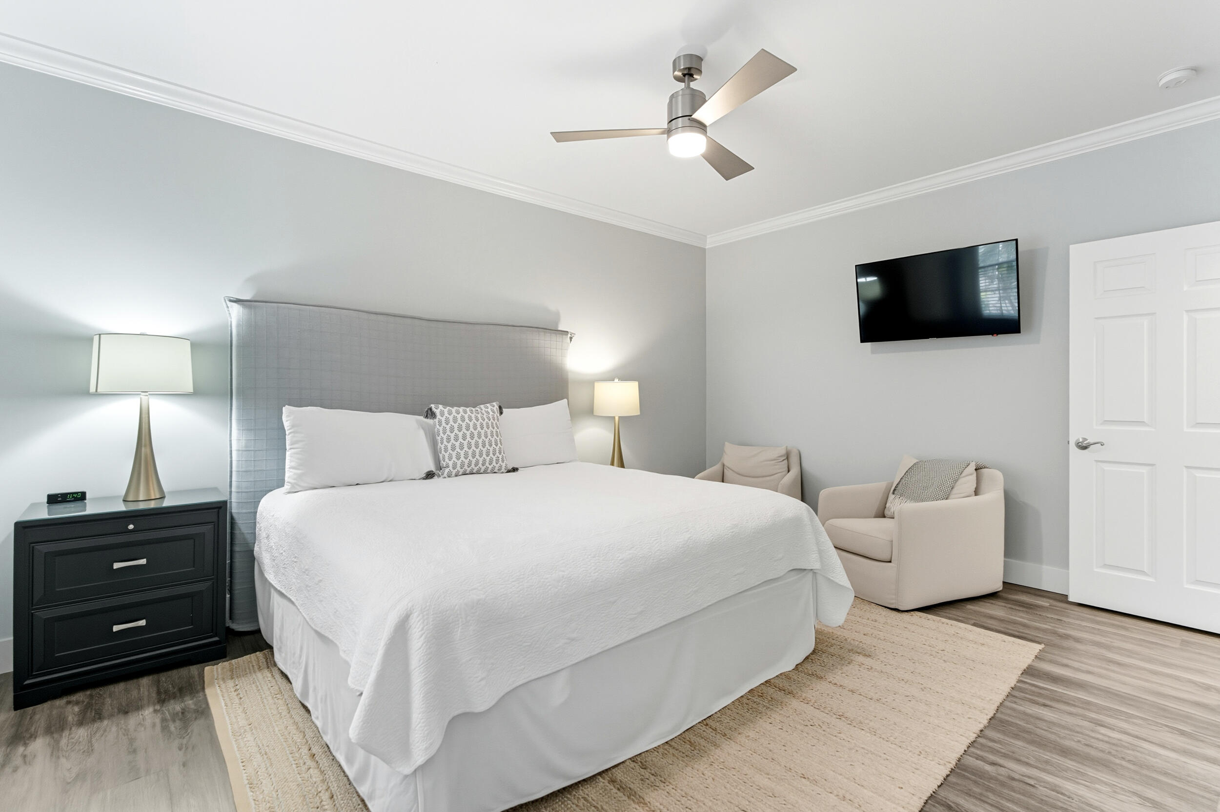 144 Hickory Street Santa Rosa Beach, FL 32459 - Photo 23 of 60 a bedroom with a bed a couch and a flat screen tv