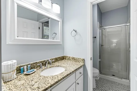 a view of a hallway with wooden floor and entryway