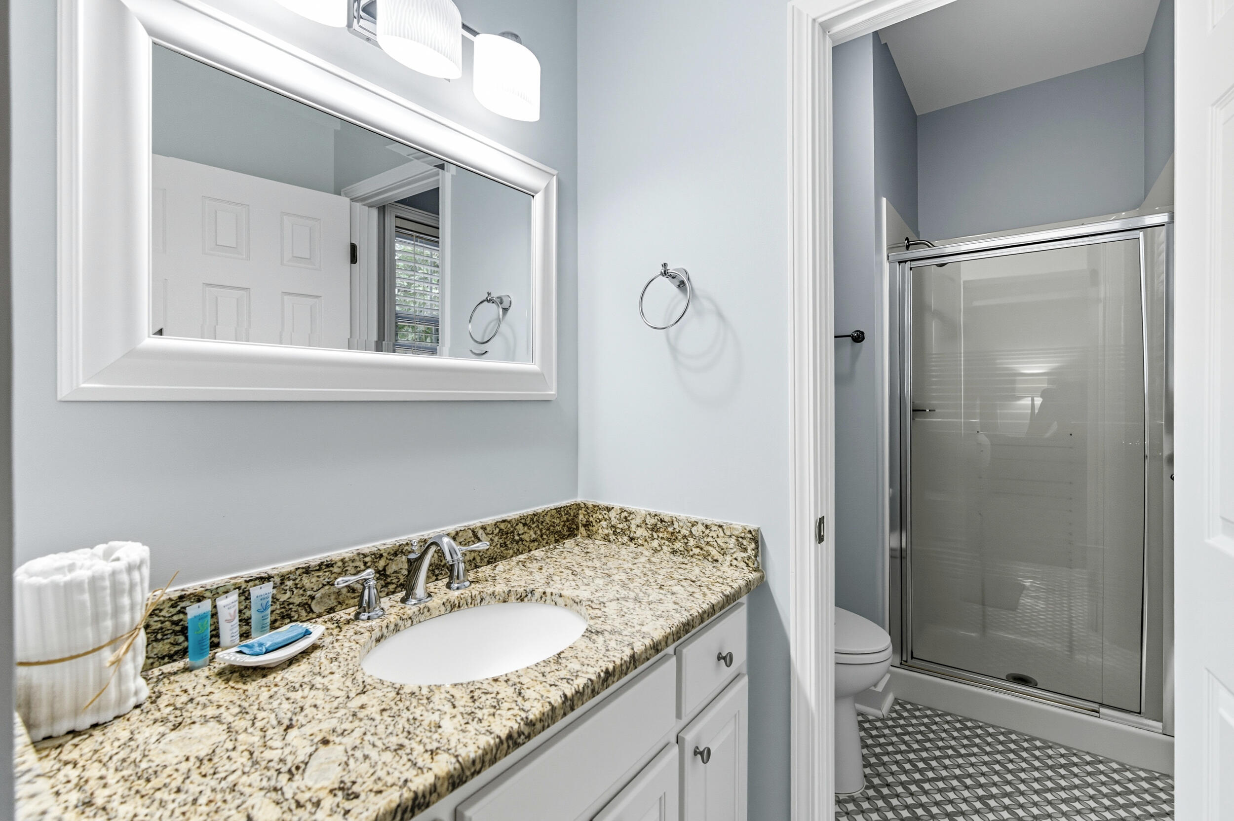 144 Hickory Street Santa Rosa Beach, FL 32459 - Photo 24 of 60 a bathroom with a granite countertop sink toilet and shower