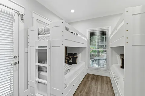 a bedroom with a bed a table and flat screen tv
