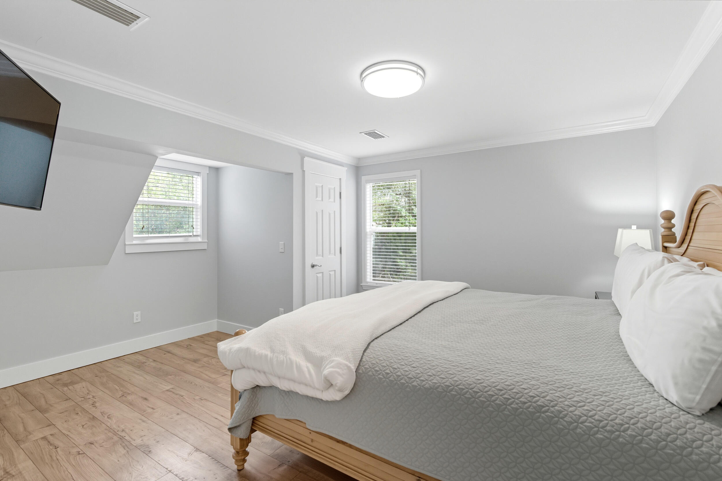 144 Hickory Street Santa Rosa Beach, FL 32459 - Photo 30 of 60 a bedroom with a bed and wooden floor