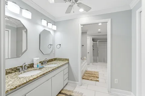 a bathroom with a granite countertop sink a toilet and a mirror