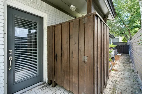 a pathway of a house with potted plants