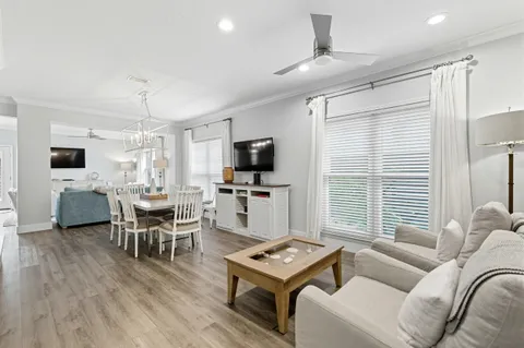 a living room with furniture a dining table and chairs