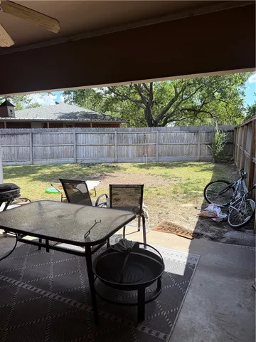 a view of backyard with swimming pool and outdoor seating