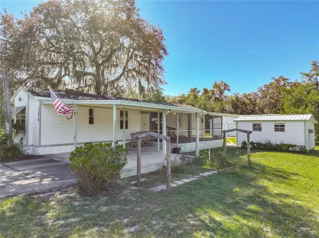 a view of a house with backyard porch and sitting area