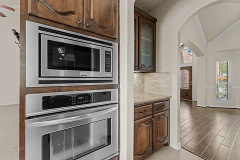 a kitchen with stainless steel appliances granite countertop a refrigerator and cabinets